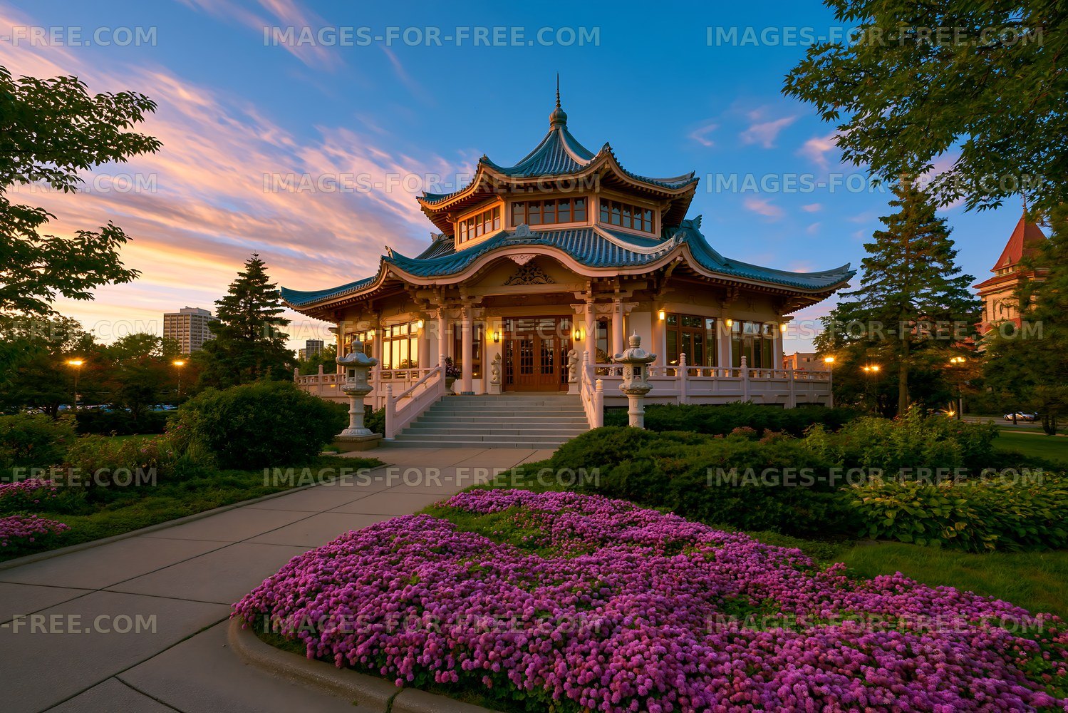 Ornate pavilion surrounded by flowers at sunset