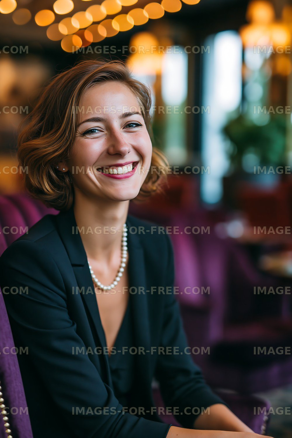 Smiling woman wearing pearls in a stylish interior setting