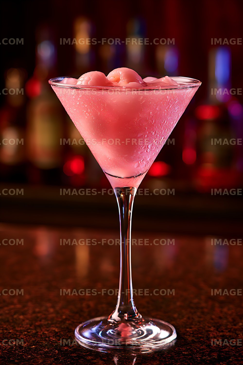 Chilled pink drink in martini glass against colorful blurred lights