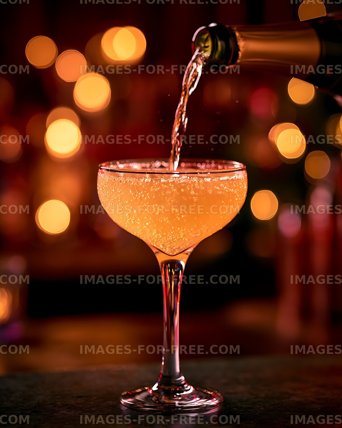 Orange cocktail poured into an elegant coupe glass