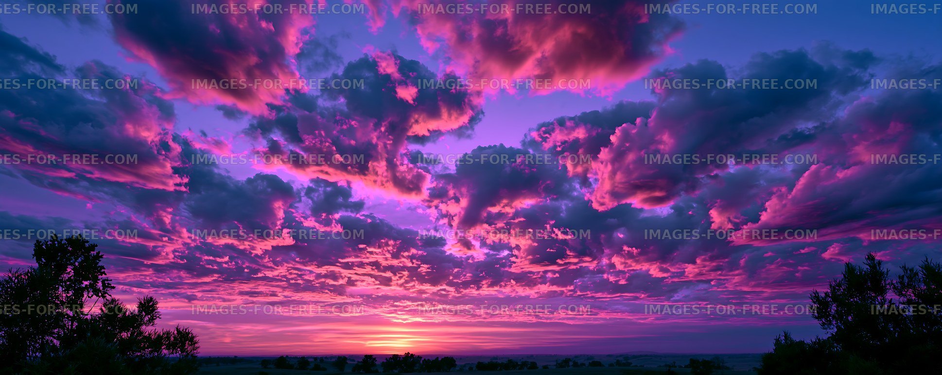 Colorful sunset clouds above a rural horizon