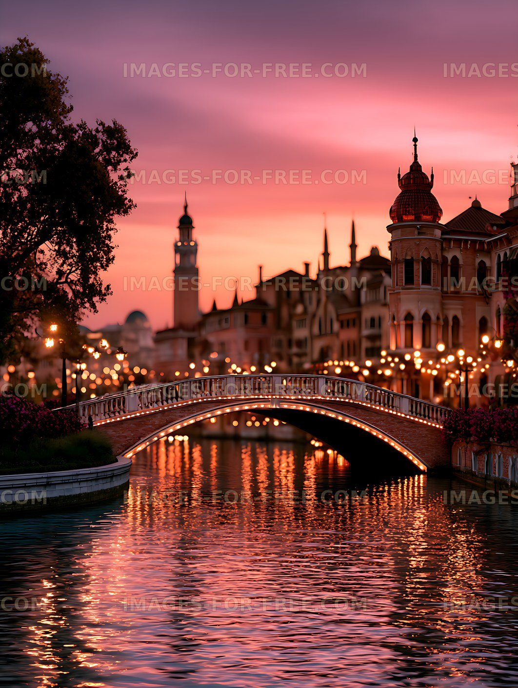 Pink sunset over an illuminated canal bridge