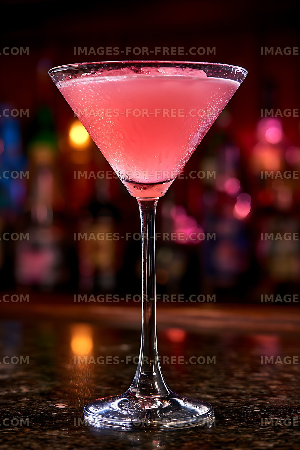 Pink drink served in a clear martini glass