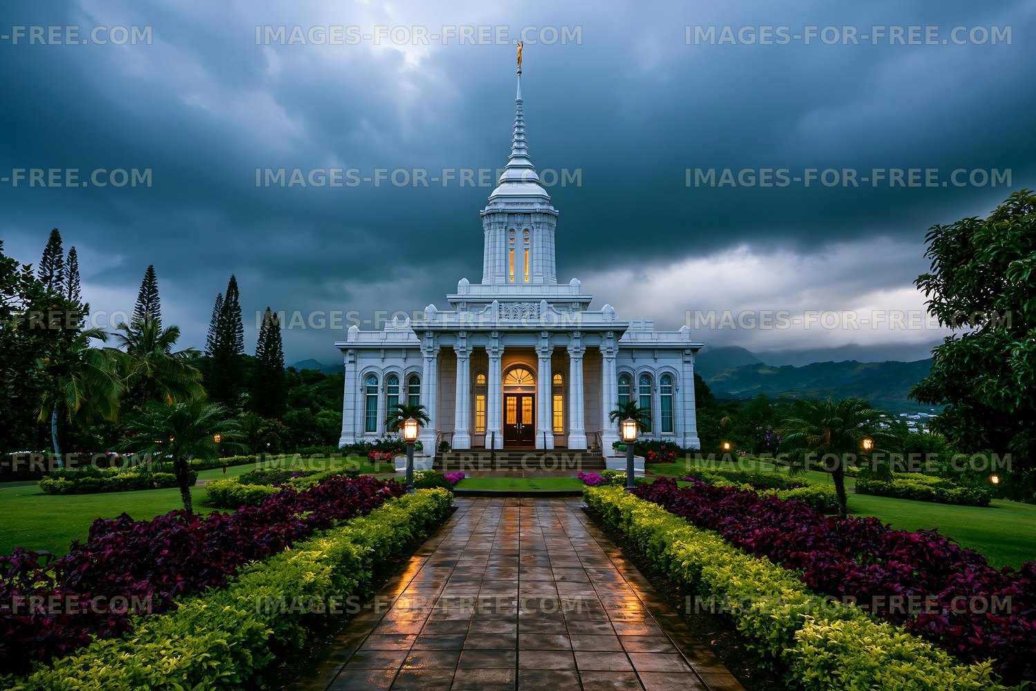 Illuminated white temple in a tropical garden after rain