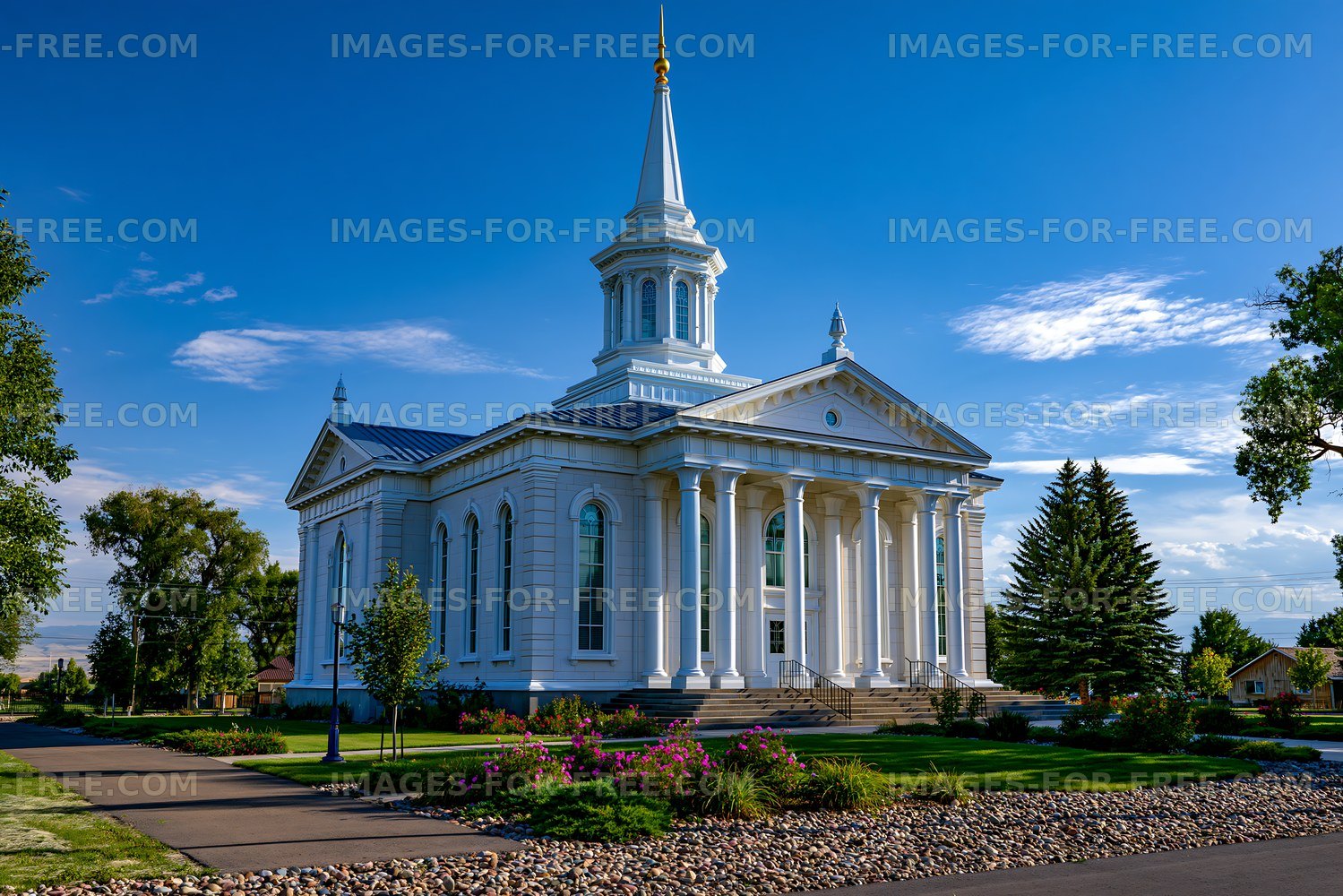 White church exterior with classical columns and gardens