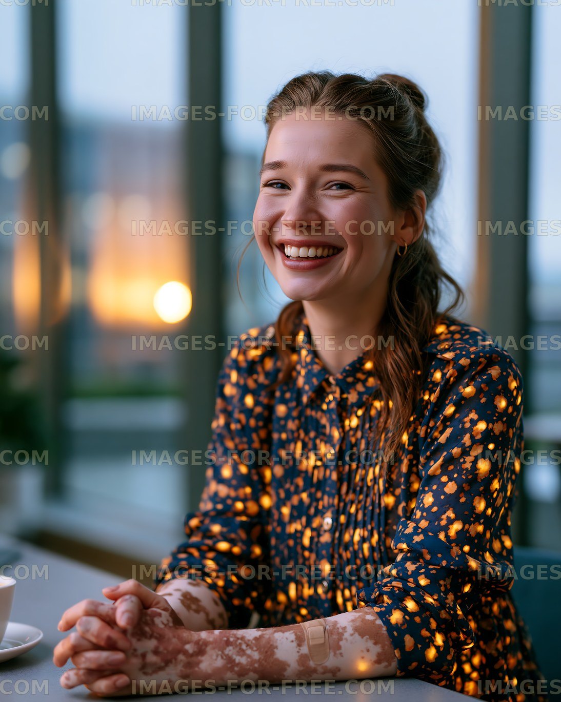 Joyful woman smiling at a table indoors