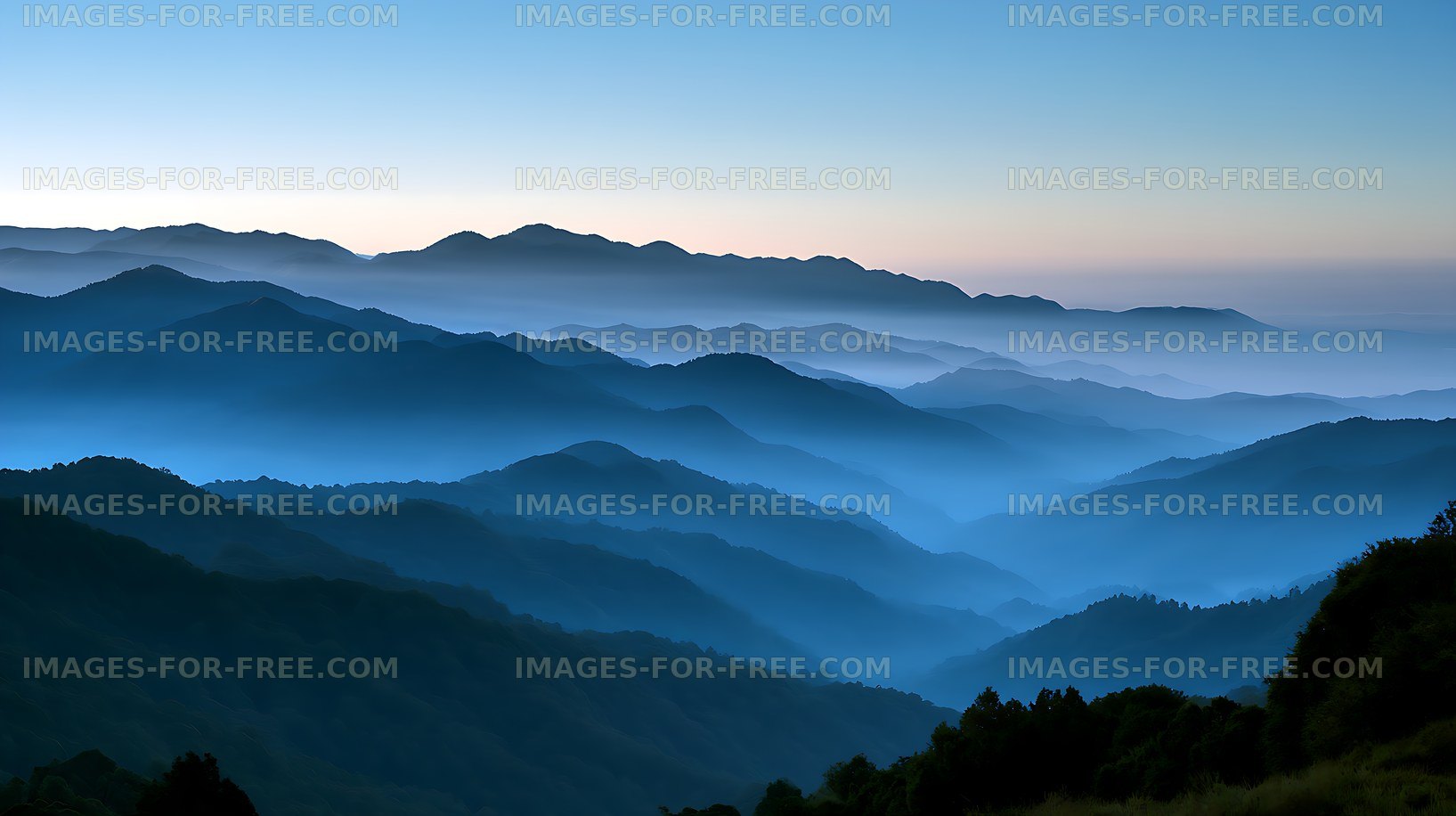 Layered mountain landscape in blue morning mist