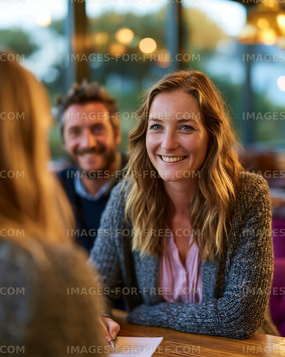 Happy woman enjoying a café conversation