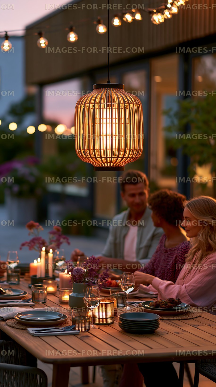 Warm outdoor dining scene with pendant lighting