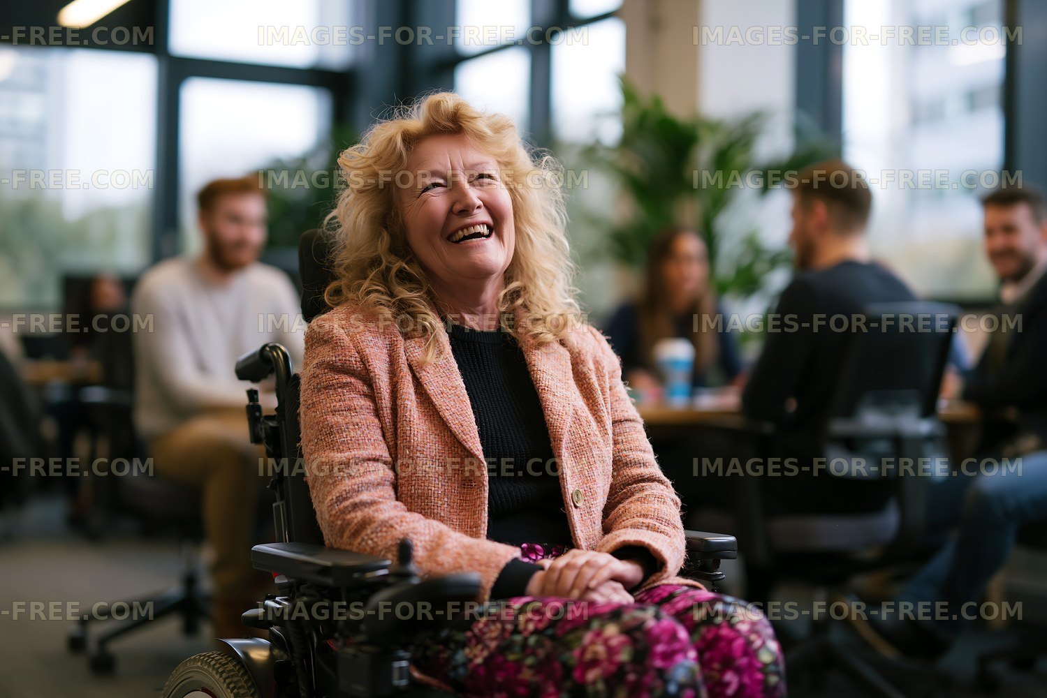 Laughing woman in wheelchair at an indoor gathering