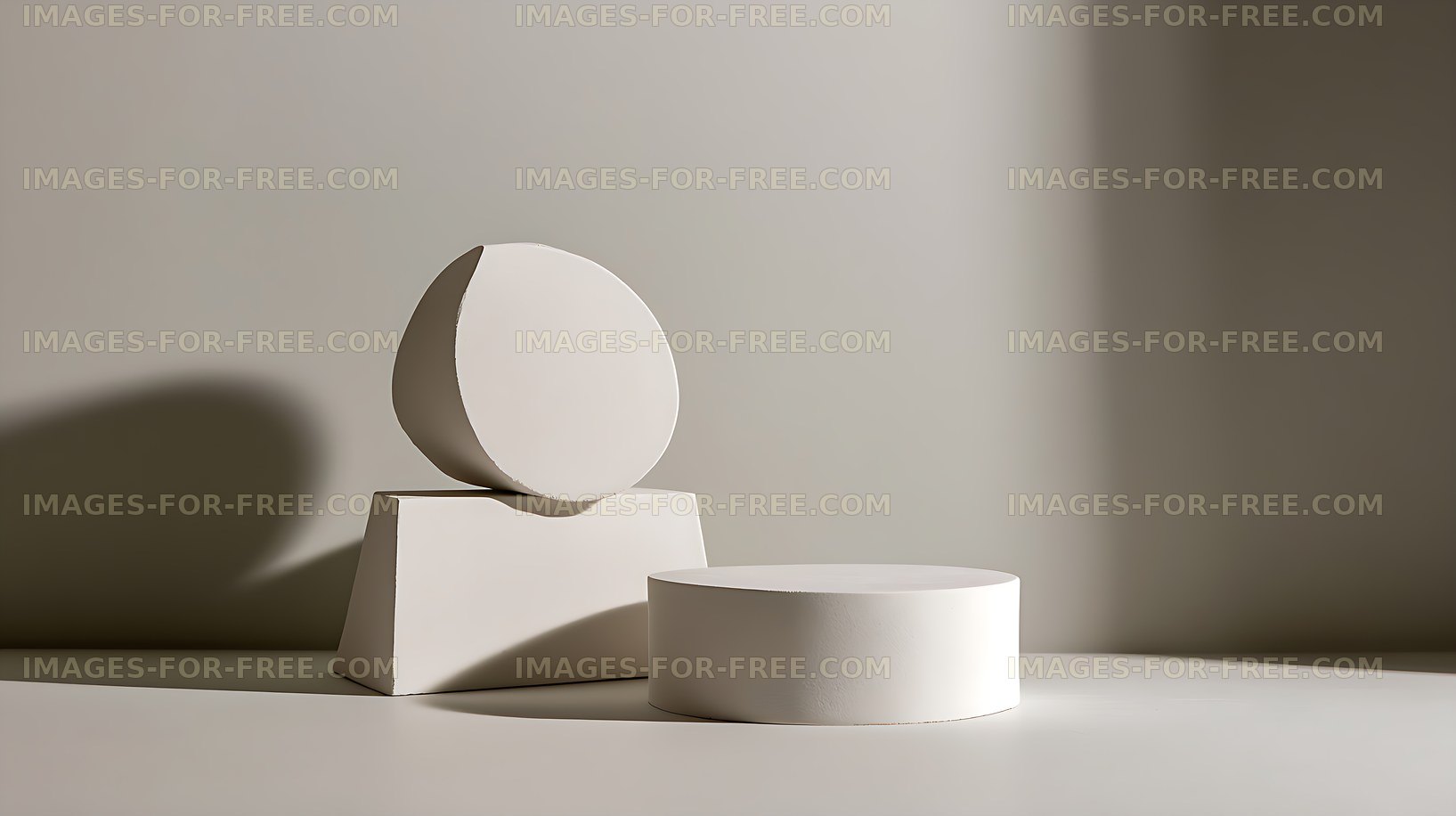 White geometric sculpture forms in a minimalist studio