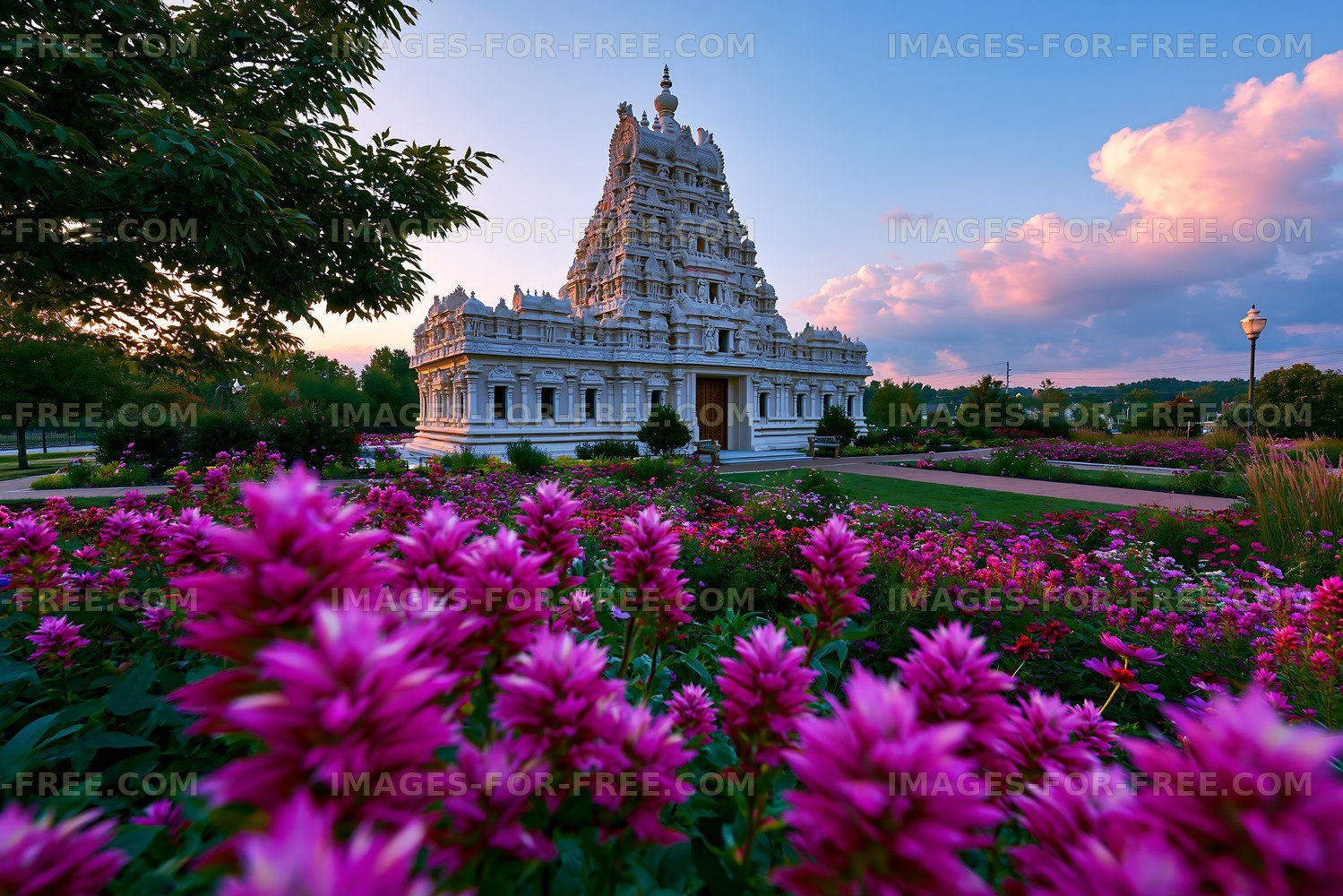 White ornate temple in a vibrant flower garden