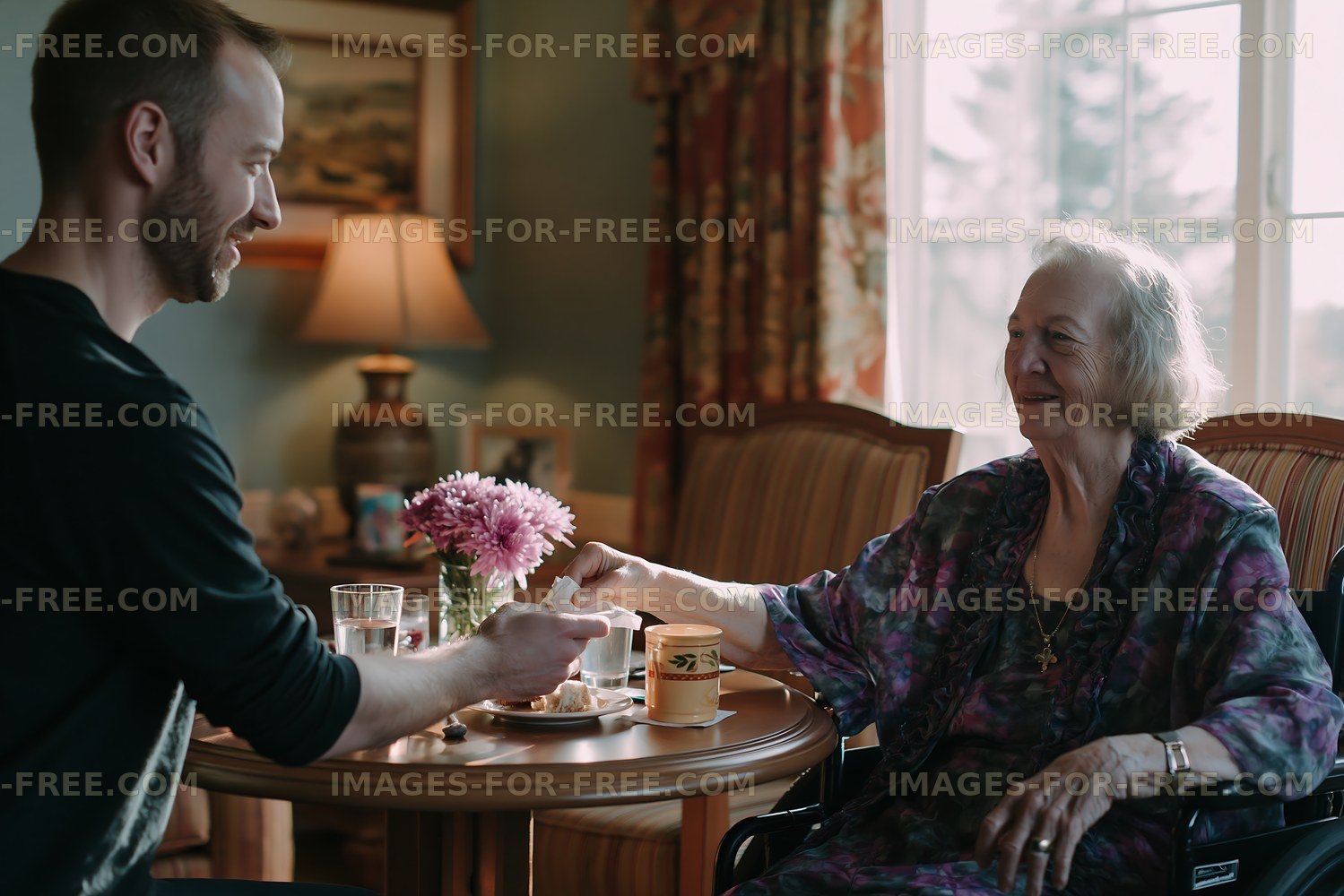 Caregiver assisting senior woman during tea at home