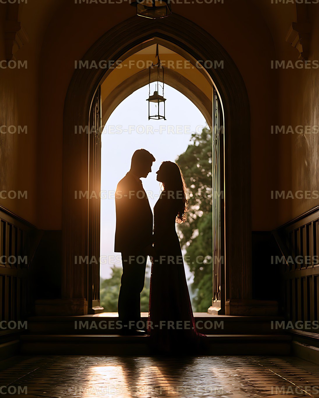 Romantic couple silhouetted in a sunlit archway