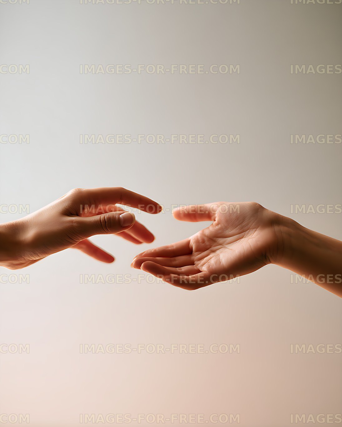 Two hands reaching toward each other in soft warm light