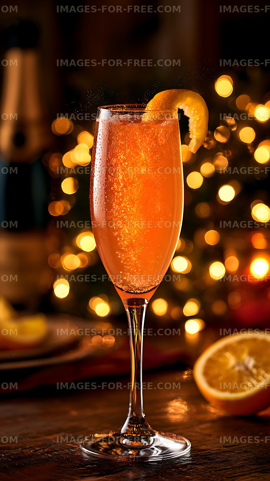 Orange sparkling drink with citrus garnish and warm bokeh