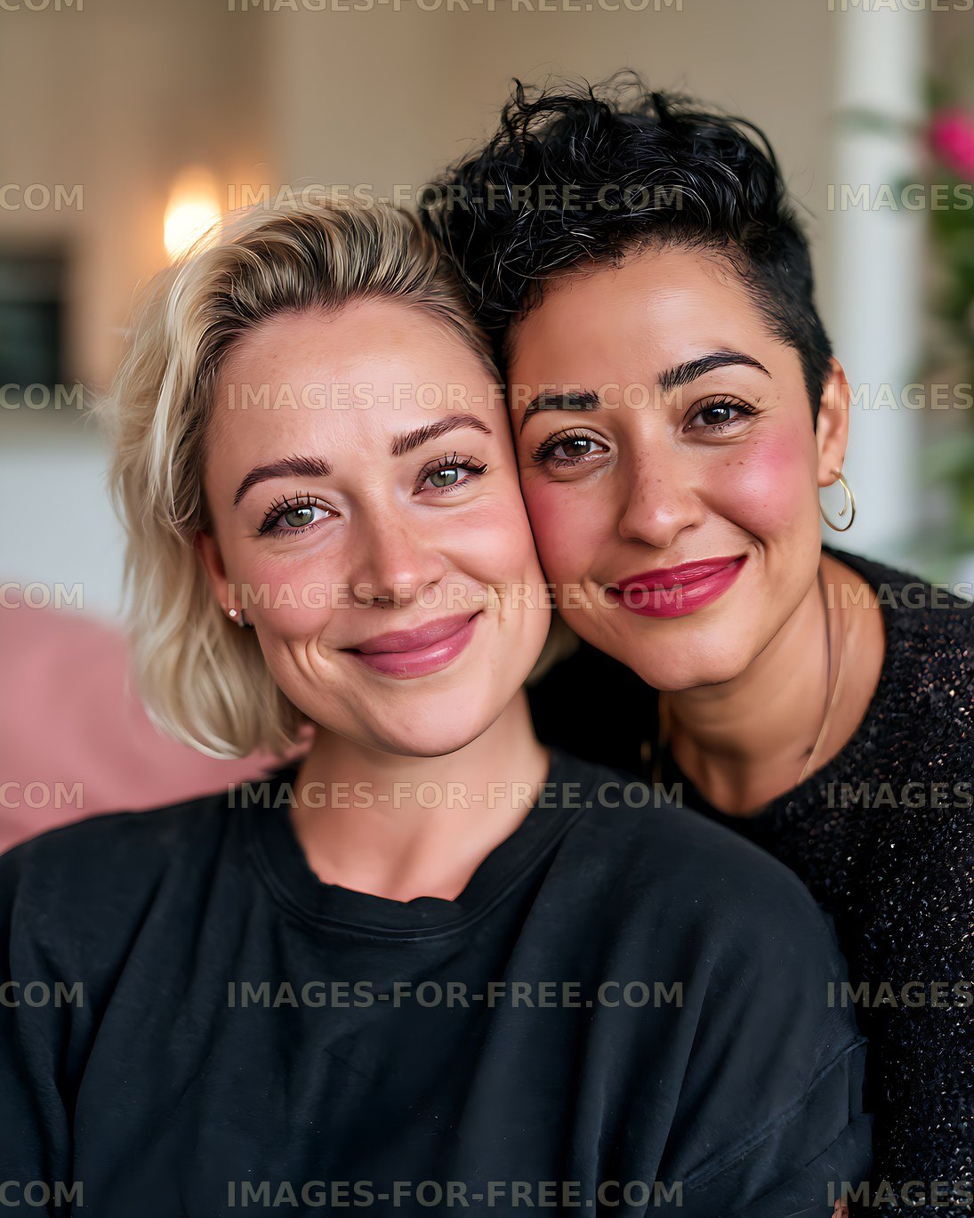 Close portrait of two smiling women together indoors