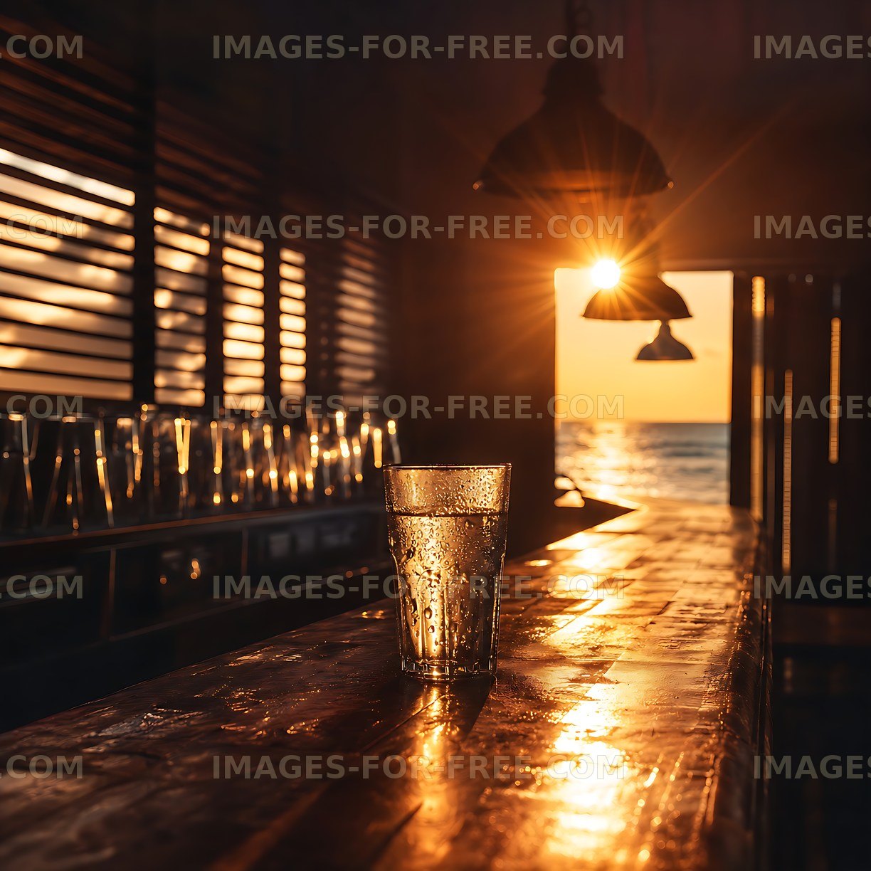 Sunset view with a glass on a wooden bar