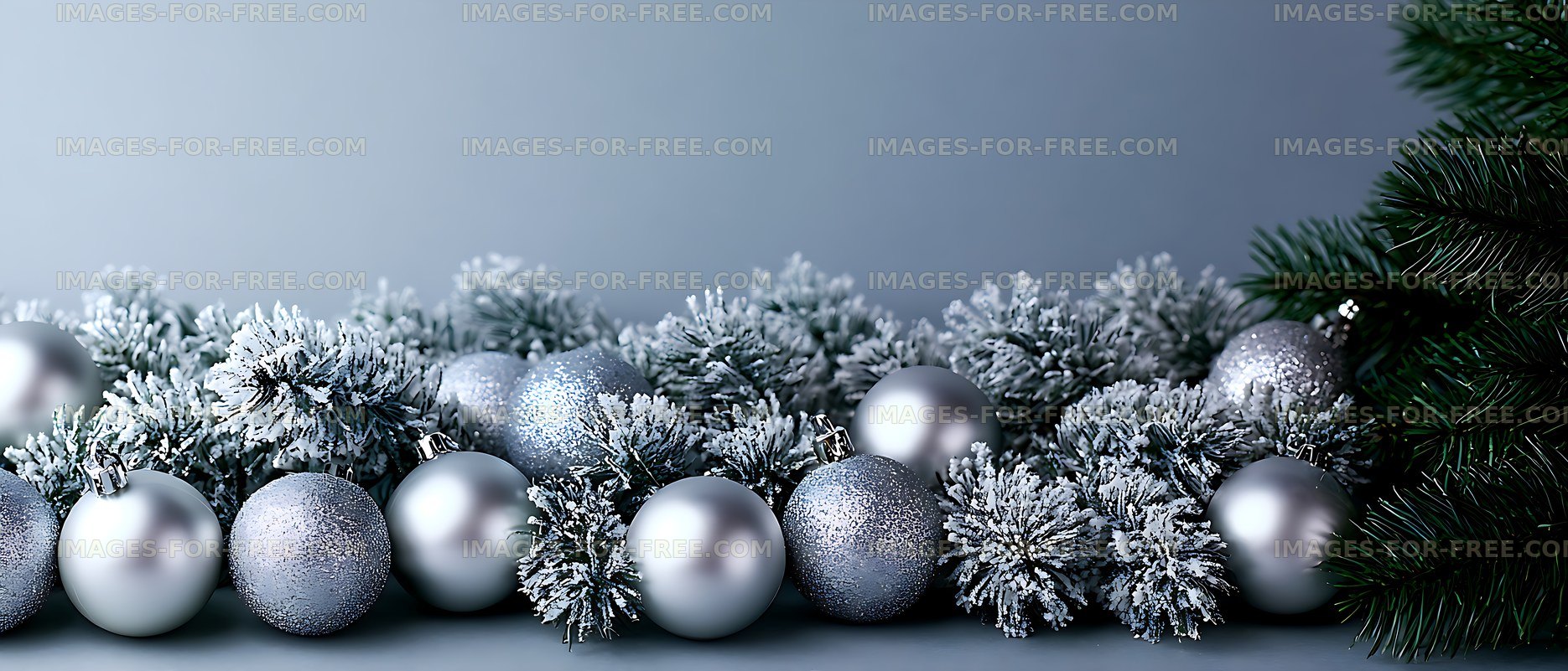 Frosted evergreen branches with silver holiday baubles