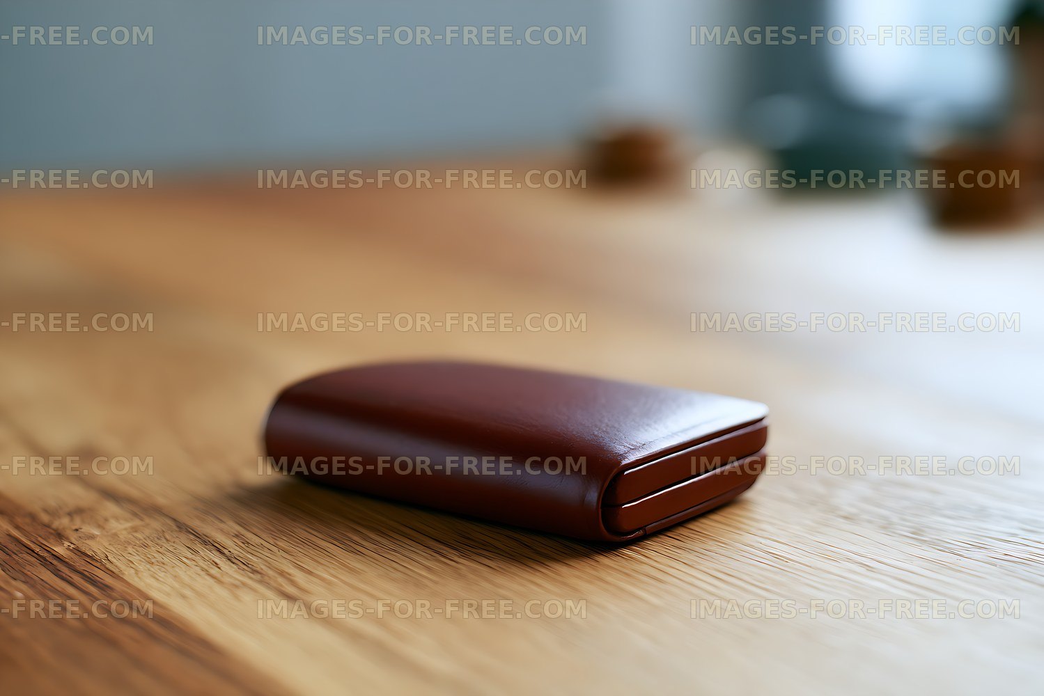 Brown leather wallet resting on wood