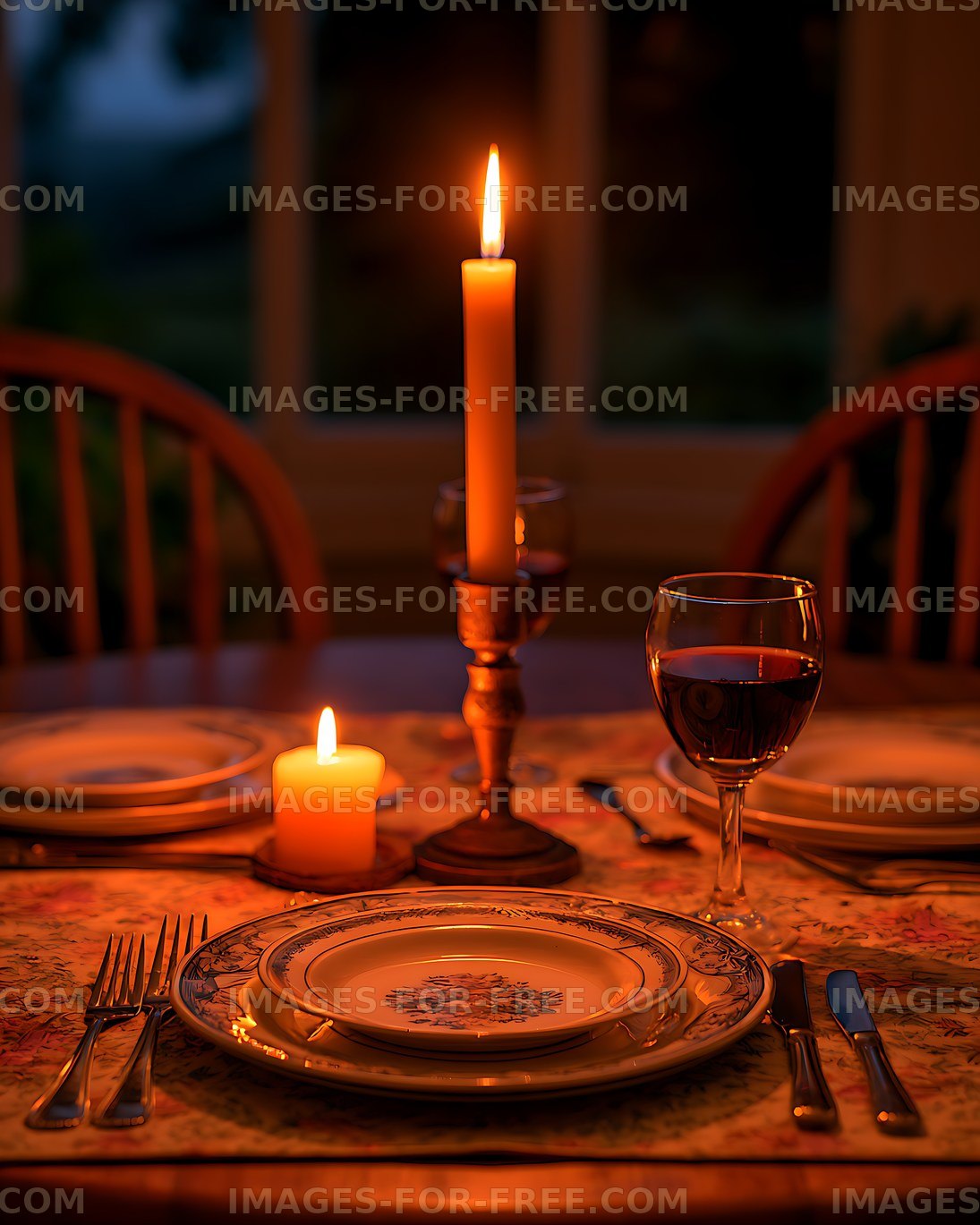 Elegant candlelit dining table with wine glass