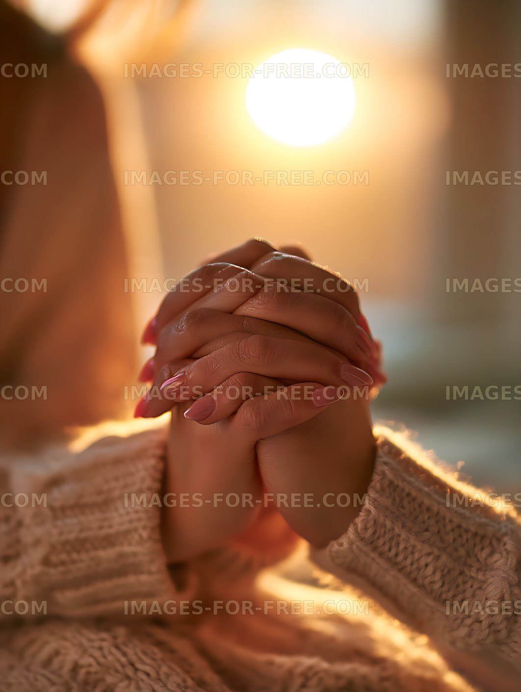 Person holding clasped hands in golden light