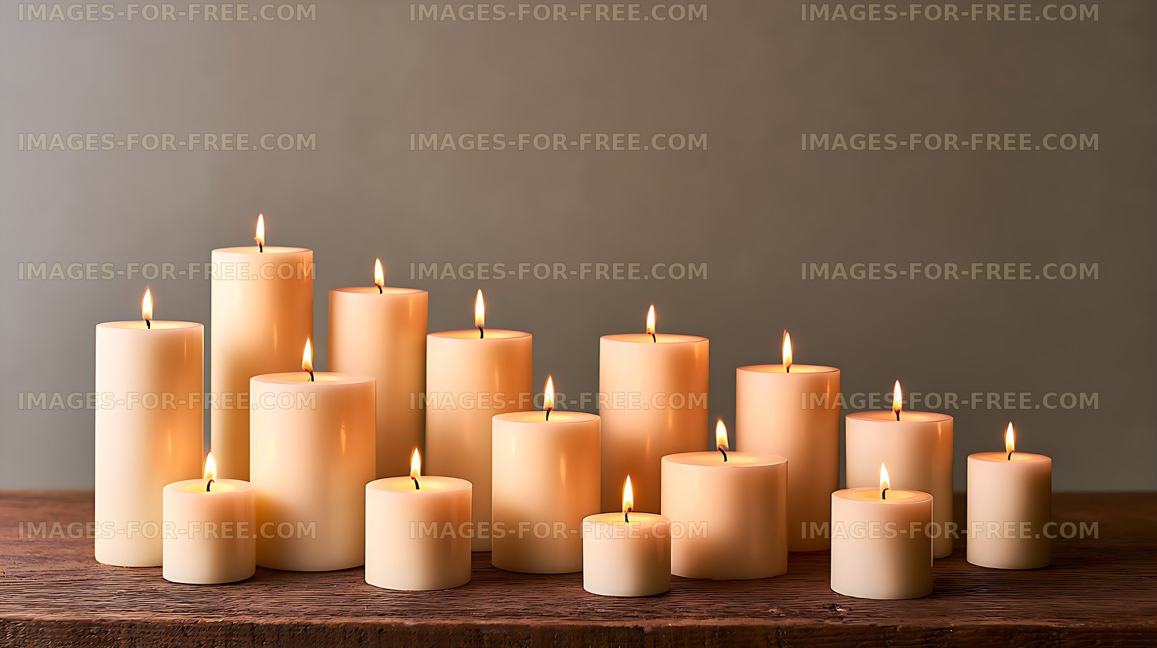 Warm lit pillar candles arranged on a wooden table