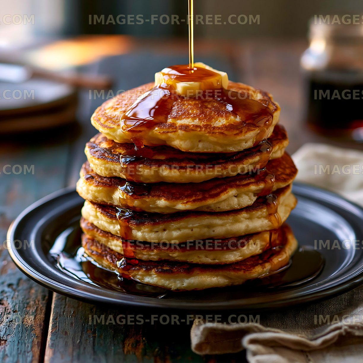 Golden pancake stack with syrup and butter