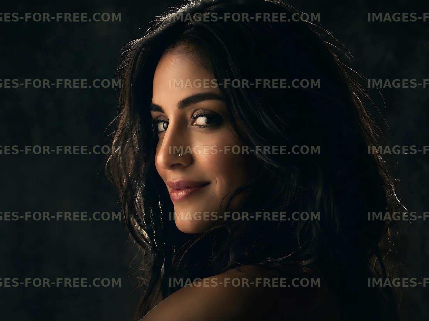 Woman with long dark hair looking over her shoulder