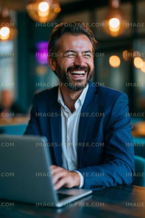 Businessman working on laptop in urban cafe