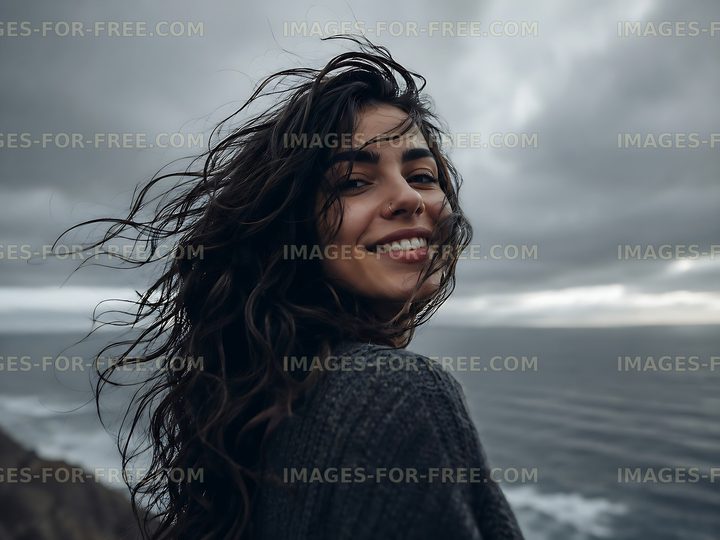 Woman smiling with ocean view on a cloudy day
