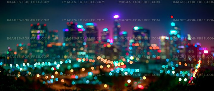 Bright city lights illuminate the skyline at night