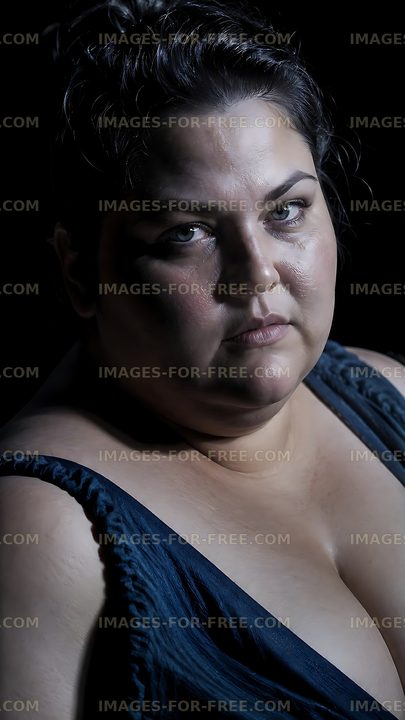 Woman with a serious expression in dark lighting