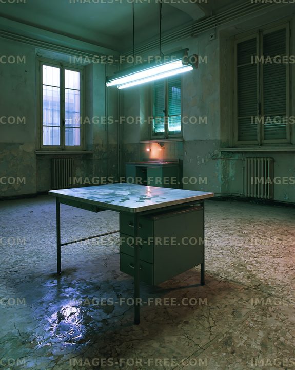 Old office space with a table and fluorescent lights