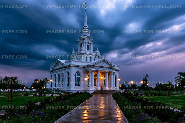 Church building under cloudy sky with wet pathway at dusk