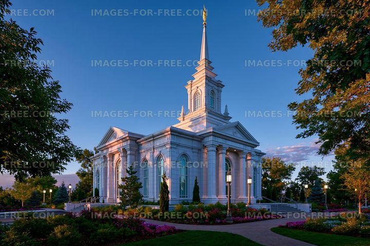 Church building surrounded by gardens during sunset