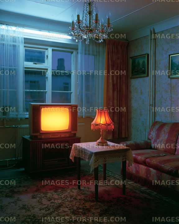 Living room with vintage television and lamp at night