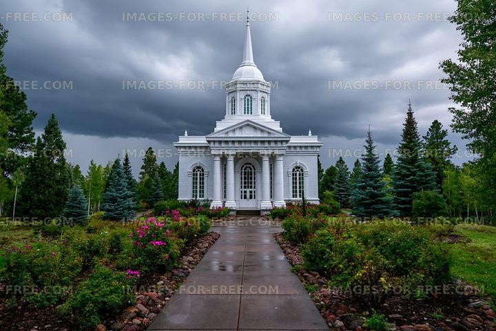 White church building surrounded by greenery and dark clouds