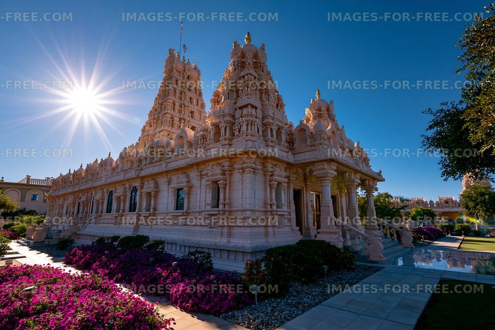 Temple structure with detailed carvings and bright sunlight