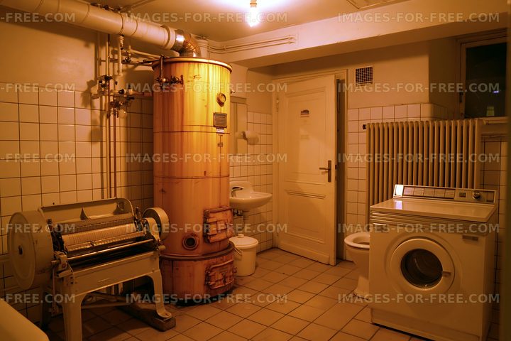 Old laundry room with vintage washing machine and water heater