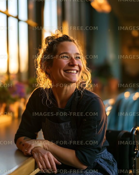 Smiling woman wearing an apron works at a cafe in the evening