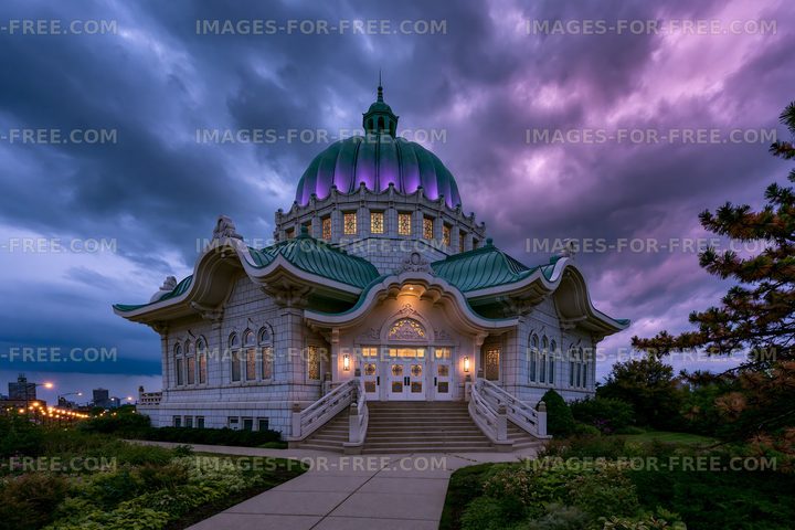 Historic building with green dome under dramatic sky