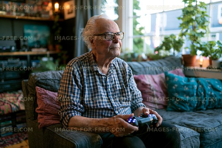 Elderly man playing video games in a cozy living room