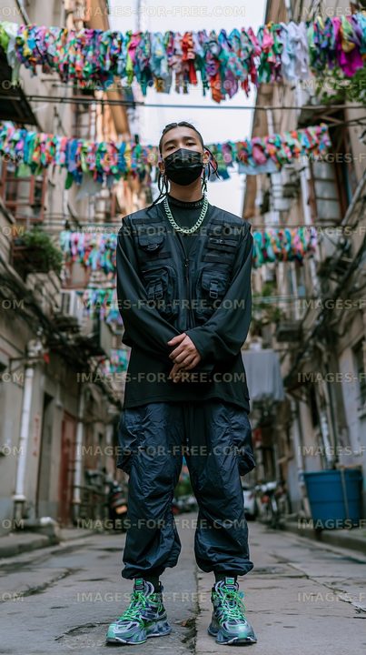 Person stands in a narrow street with colorful clothes hanging above