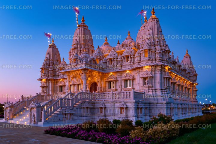 Detailed view of a large temple at dusk with decorative lights