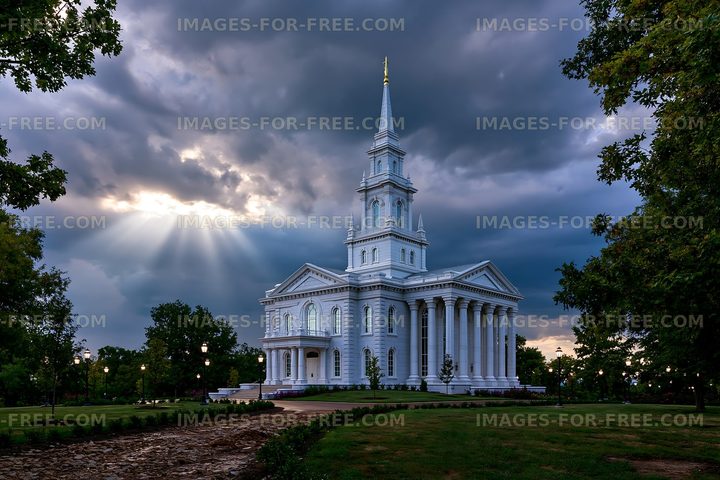 White church building under cloudy sky with sunlight beams