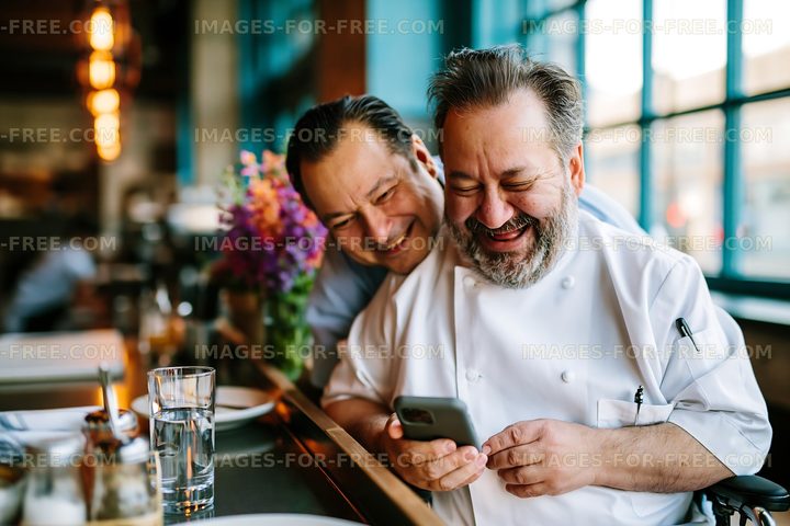 Two men smiling and enjoying time together in a restaurant