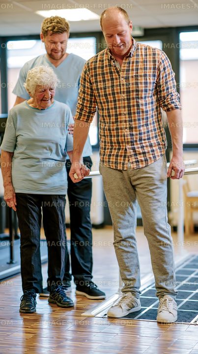 Senior woman observing physical therapy session with a man