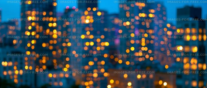 City skyline at dusk with blurred lights shining