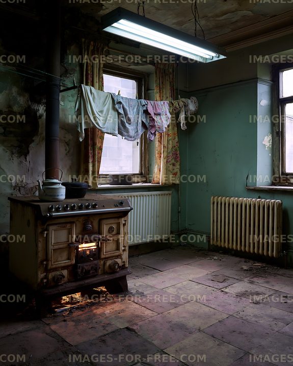 Old kitchen with a stove and hanging clothes in a rundown room